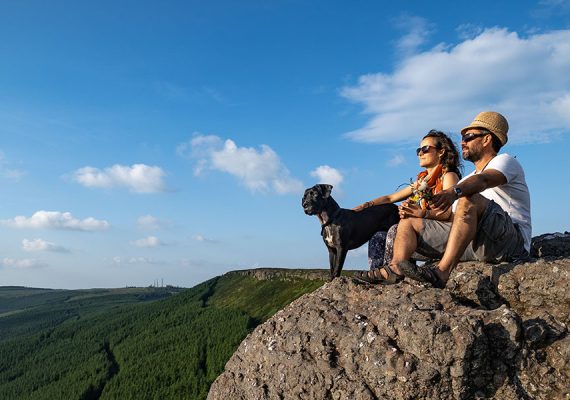 Image of Couple sitting with dog on birchill loop